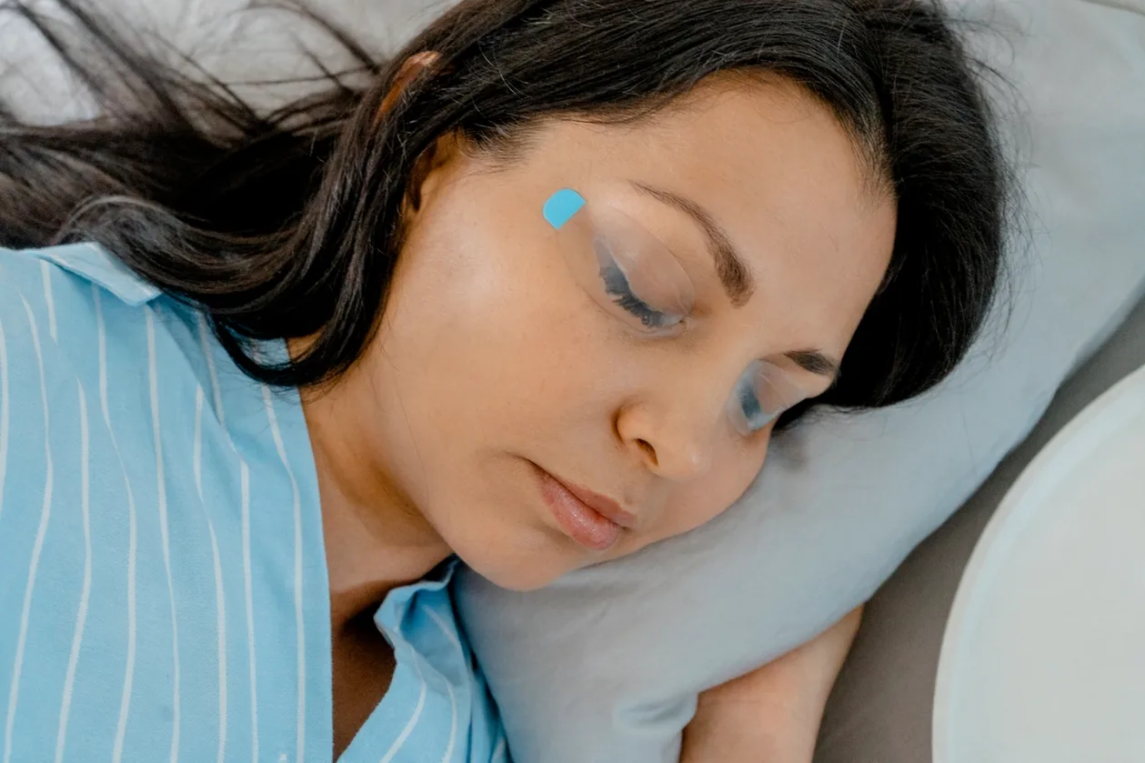 A calm closed eye with a soft EyeLotus strip resting over the lid